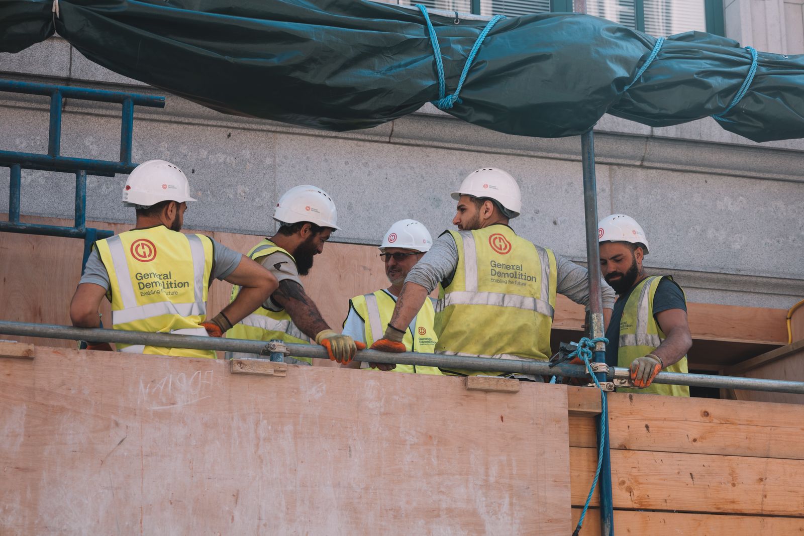 Roofing professionals reviewing plans on site